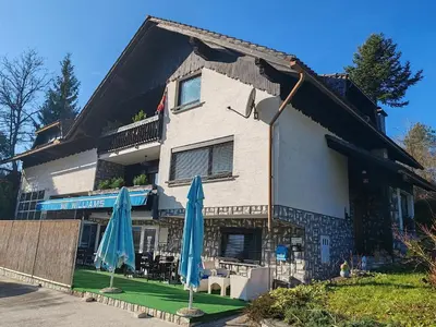 two blue umbrellas in front of a building at Apartment Prešeren in Smarjeske Toplice