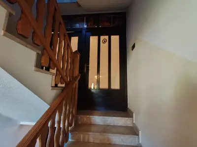 a hallway with a black door and stairs at Apartment Prešeren in Smarjeske Toplice
