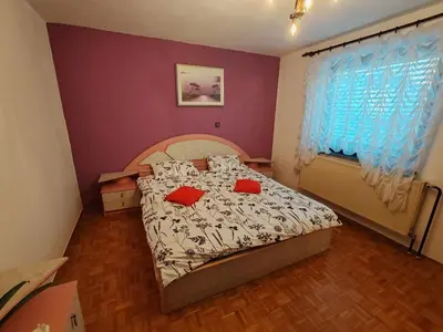 a bedroom with a bed with red pillows on it at Apartment Prešeren in Smarjeske Toplice