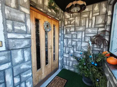 a front door of a stone house with a christmas tree at Apartment Prešeren in Smarjeske Toplice