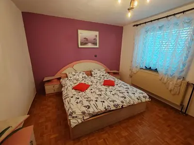 a bedroom with a bed with red pillows on it at Apartment Prešeren in Smarjeske Toplice