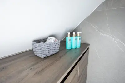 a bathroom with a counter with bottles on it at 4 Elements Glamping & Apartments in Bled