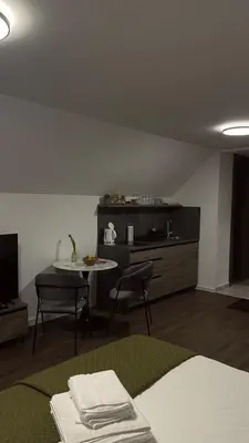 a room with a kitchen with a table and chairs at 4 Elements Glamping & Apartments in Bled