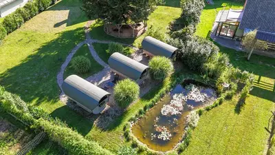 an overhead view of a garden with three white tanks at 4 Elements Glamping & Apartments in Bled