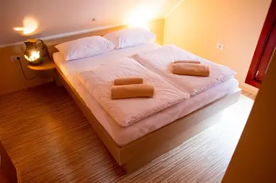a bedroom with a bed with two towels on it at HIŠA ROSA in Veržej