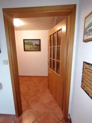a hallway leading into a room with a door at Apartma ČVRSTA TROJKA in Jesenice