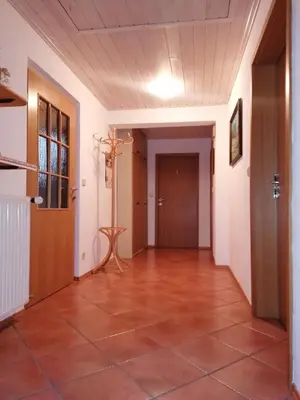 an empty hallway with a tile floor and a door at Apartma ČVRSTA TROJKA in Jesenice