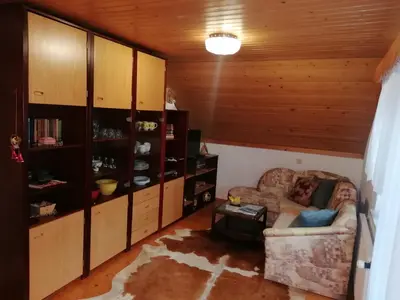a living room with a couch and a table at Apartma ČVRSTA TROJKA in Jesenice