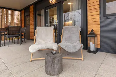two chairs and a table on a patio at Apartma LeMa in Velike Lašče
