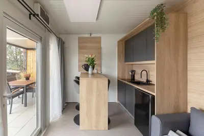 a small kitchen and dining room in a tiny house at Apartma LeMa in Velike Lašče