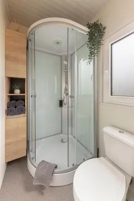 a glass shower in a bathroom with a toilet at Apartma LeMa in Velike Lašče