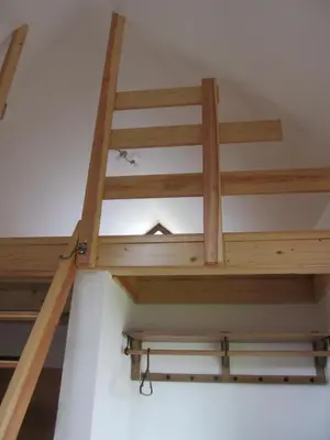 a staircase in a room with wooden ceilings at Apartment Sever in Idrija
