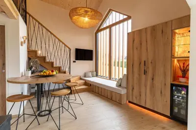 a kitchen with a table and chairs and a window at Luxury Resort Potatoland in Šenčur