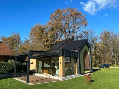 a modern house with a black roof at Luxury Resort Potatoland in Šenčur
