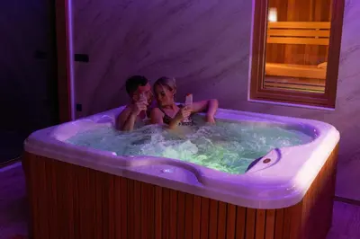 a man and a woman sitting in a bath tub at Luxury Resort Potatoland in Šenčur