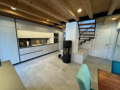 a large kitchen with a staircase in a house at Gloria Holiday - Kranjska Gora Apartments in Kranjska Gora