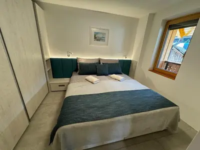 a bedroom with a large bed in a room at Gloria Holiday - Kranjska Gora Apartments in Kranjska Gora