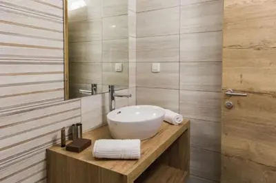 a bathroom with a white sink and a mirror at EnDi Rooms in Ljubljana