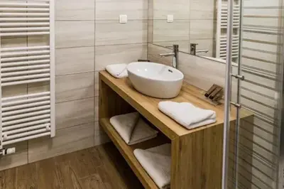a bathroom with a sink and a mirror at EnDi Rooms in Ljubljana