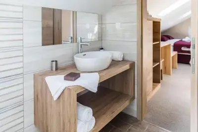 a bathroom with a sink and a mirror at EnDi Rooms in Ljubljana