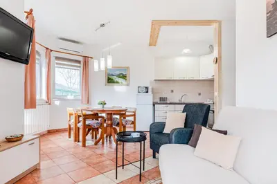 a living room with a couch and a table at Apartma Brešan in Kobarid