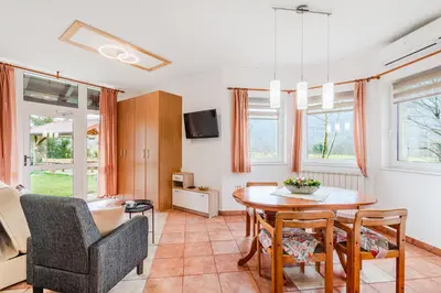 a living room with a table and chairs at Apartma Brešan in Kobarid