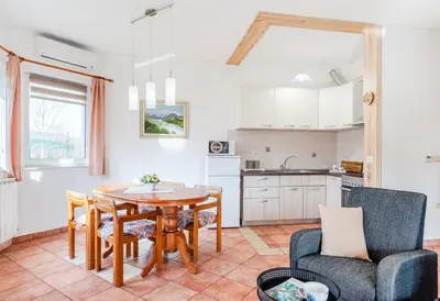 a kitchen and dining room with a table and chairs at Apartma Brešan in Kobarid