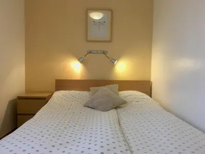 a bedroom with a bed with a pillow on it at Apartment Muznik in Bled