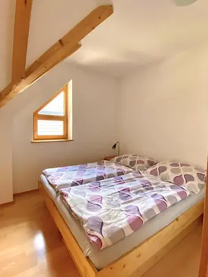 a bedroom with a bed in a attic at Apartment Iris in Bohinj