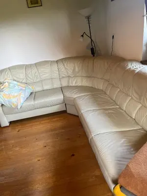 a white couch sitting in a living room at Hiška pri Vrjaku in Bohinjska Bistrica