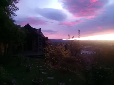 a sunset view from the backyard of a house at Apartment Tagrajska in Ljubljana