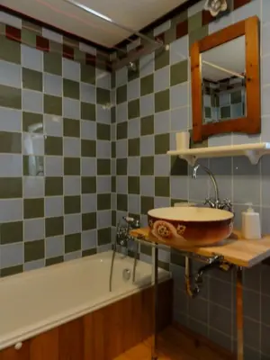 a bathroom with a sink and a bath tub at Apartment Tagrajska in Ljubljana