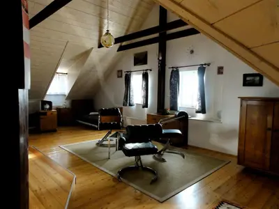a living room with a chair and a couch at Apartment Tagrajska in Ljubljana