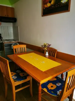 a dining room table with a yellow table cloth on it at Country House Fon in Kobarid