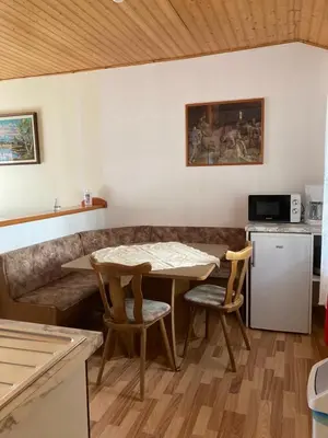 a living room with a table and chairs and a couch at Country House Fon in Kobarid