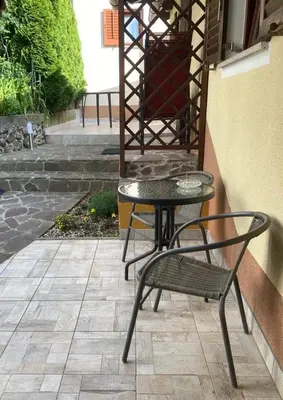 a table and a chair on a patio at Country House Fon in Kobarid