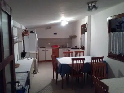 a kitchen with a table and chairs in a kitchen at Country House Fon in Kobarid