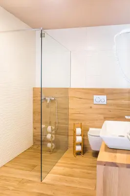 a bathroom with a shower and a toilet and a sink at Hotel Penzion Kobala in Tolmin