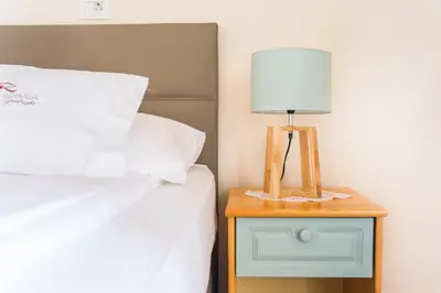 a lamp on a night stand next to a bed at Hotel Penzion Kobala in Tolmin