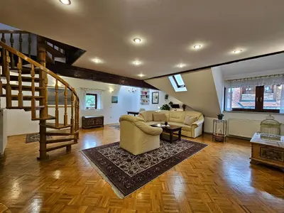 a living room with a couch and a staircase at Apartment Nina with private terrace Tour As Ljubljana in Ljubljana