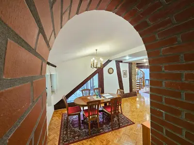a dining room with a brick wall and a table and chairs at Apartment Nina with private terrace Tour As Ljubljana in Ljubljana