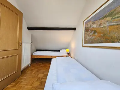 a small room with two beds and a painting at Apartment Nina with private terrace Tour As Ljubljana in Ljubljana