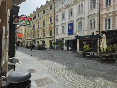 an empty street in a city with buildings at Apartment Nina with private terrace Tour As Ljubljana in Ljubljana