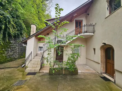 a white house with a staircase and a balcony at Apartment Nina with private terrace Tour As Ljubljana in Ljubljana