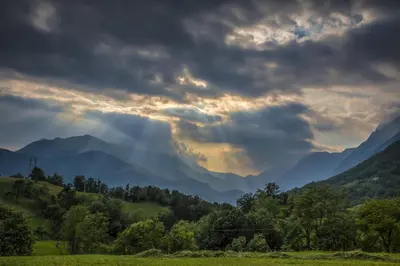 a stormy sky with clouds over a mountain range at Apartment Bric in Kobarid