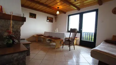 a living room with a fireplace and a table and a couch at Holiday home in Semic - Kranjska (Krain) 26078 in Semič