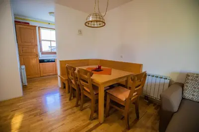 a dining room with a wooden table and chairs at Apartment Jurič in Maribor