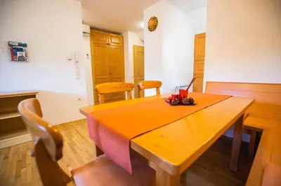 a dining room with a wooden table and chairs at Apartment Jurič in Maribor