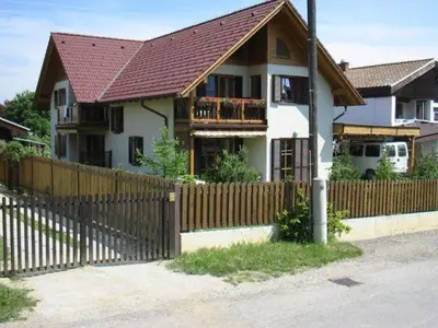 a house with a wooden fence in front of it at Apartment Jurič in Maribor