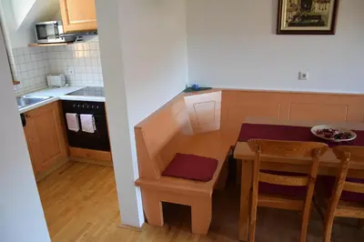 a small kitchen with a small table and chairs at Apartment Jurič in Maribor